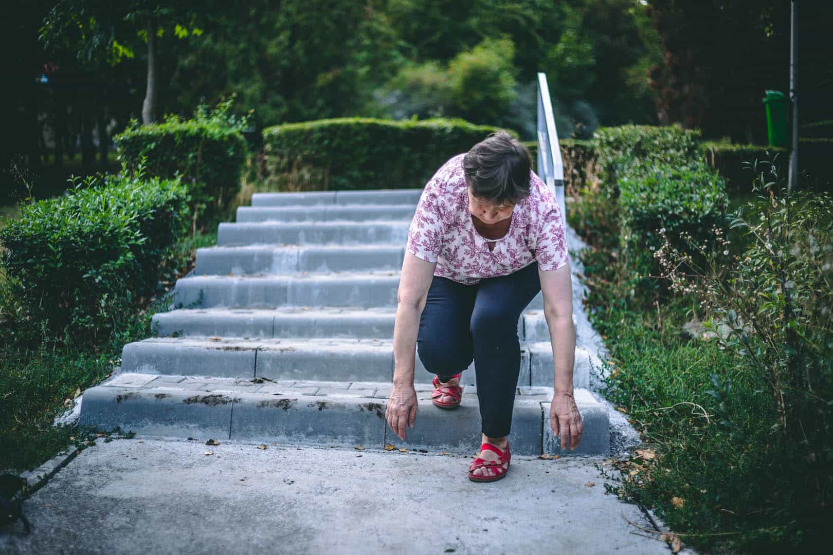 Weak,Senior,Woman,Slipping,On,Stairs,In,The,Park,- senior woman slipping and tripping on uneven concrete stairs